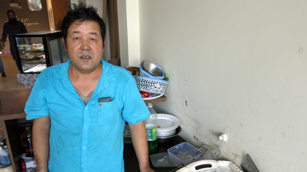 Zhang Yan Xu, the chef at Islamabad's Hong Du Ramen, works in an open air kitchen in a busy shopping plaza in Pakistan's capital, blissfully unable to communicate with most Pakistanis [Asad Hashim/Al Jazeera]