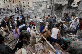 People search under rubble of a house destroyed by a Saudi-led air strike in Sanaa