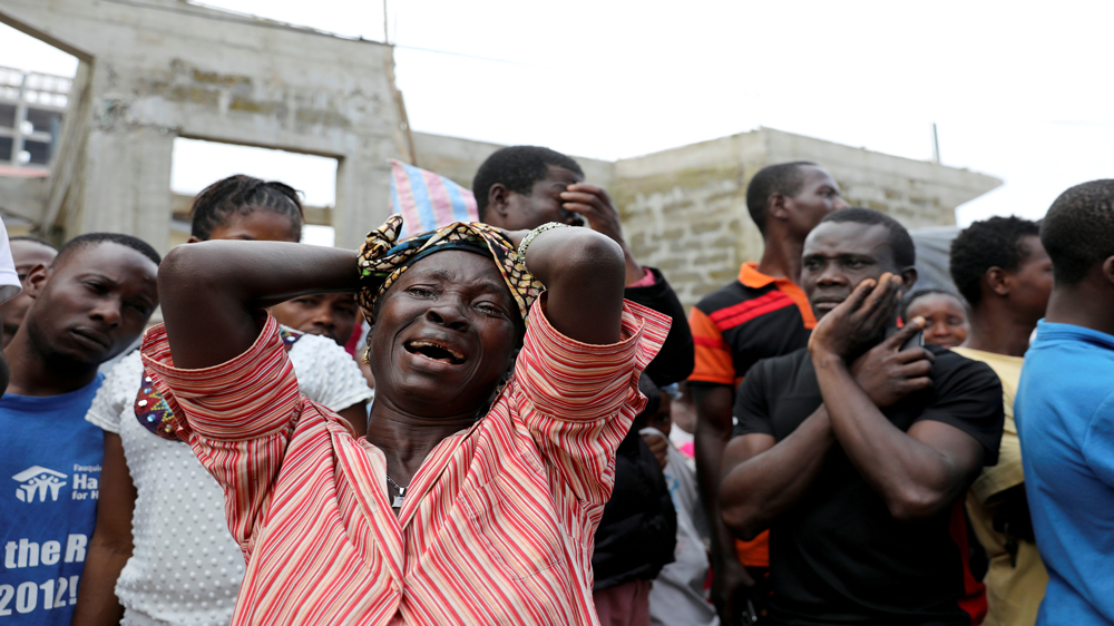 A woman mourns for her son at the entrance of Connaught Hospital in Freetown, Sierra Leone August 16, 2017 [Afolabi Sotunde/Reuters]