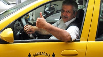 Taxi driver Ragip Meral shows his support for Turkey's re-elected prime minister [Ayse Alibeyoglu/Al Jazeera]