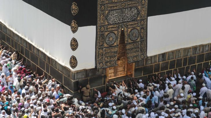 Muslim pilgrims pray at the Kaaba