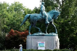 A sign on the statue of Robert E. Lee calls for the park to be renamed for Heather Heyer, who was killed at in a far-right rally, in Charlottesville, Virginia
