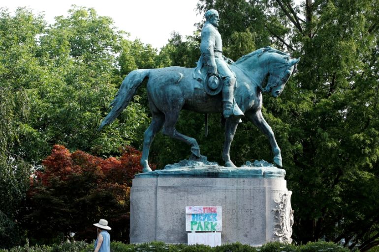 A sign on the statue of Robert E. Lee calls for the park to be renamed for Heather Heyer, who was killed at in a far-right rally, in Charlottesville, Virginia