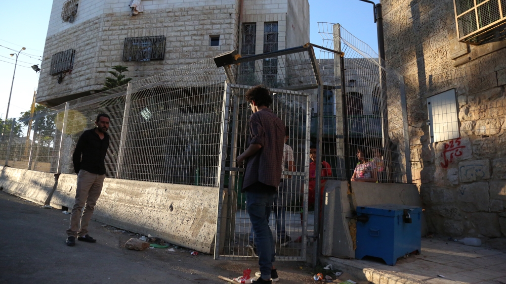 An extension of Israel's 'discrimination fence' and a gate added in front of his home in May has made Fakhuri feel besieged [Mersiha Gadzo/Al Jazeera]