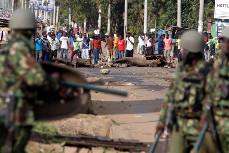 Kenyan riot policemen confront demonstrators supporting opposition leader Raila Odinga, after Odinga claimed "massive" fraud in this week''s elections, in Kisumu