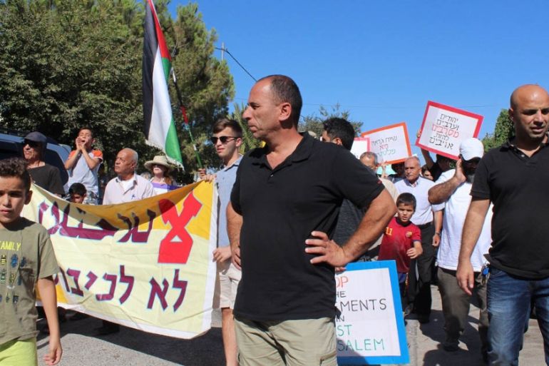 Palestinian residents of Sheikh Jarrah march with Israeli activists to protest the eviction of the Shamasne family