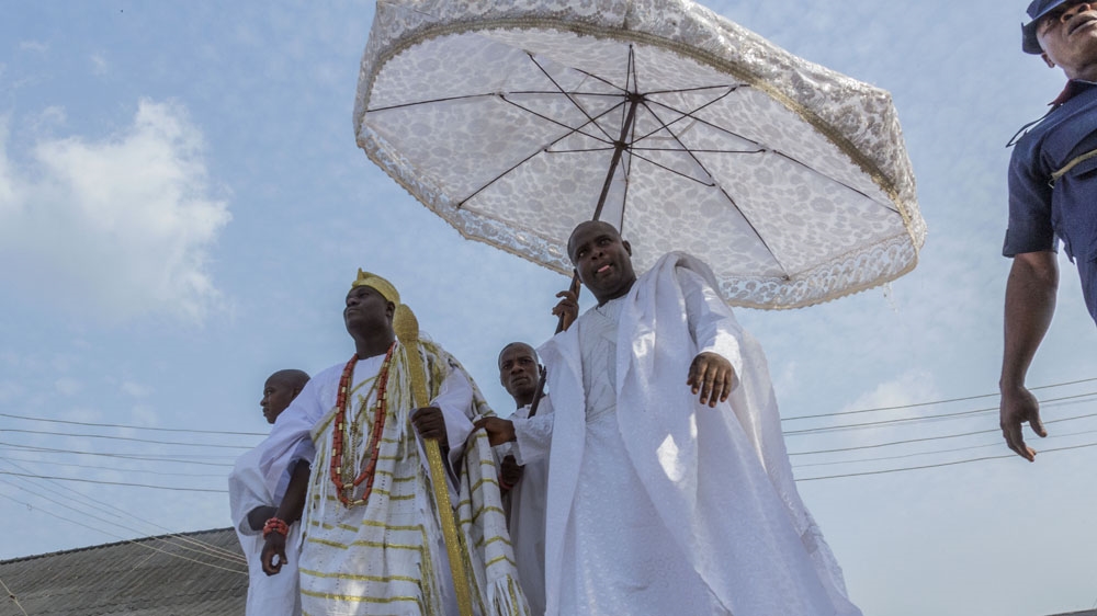The Ooni of Ife surrounded by his attendants [Andrew Esiebo/Al Jazeera]