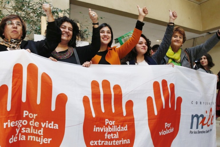 Deputies of the Socialist and Communist party hold a placard after approval of a bill to legalize abortion in certain cases during a session at Chile''s Chamber of Deputies in Valparaiso