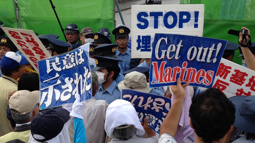 Demonstrators stage daily sit-ins outside Camp Schwab, a US Marine Corps Base in northern Okinawa where the US and Japan are forcibly building a new aircraft landing facility on reclaimed land at Cape Henoko despite lawsuits, demonstrations and international protests. Photograph taken in June, 2015 [Jon Letman/Al Jazeera] 