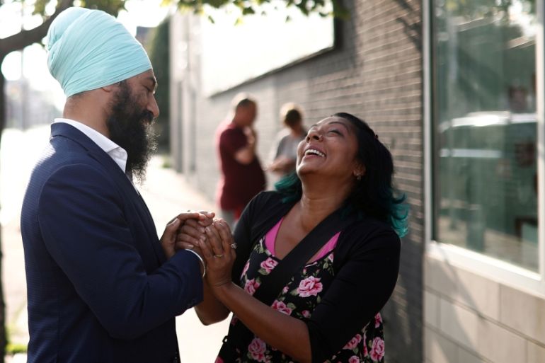 New Democratic Party leadership candidate Singh shakes hands with a woman at a meet and greet event in Hamilton