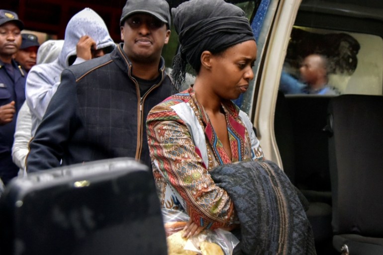 Diane Shima Rwigara, a leading critic of Rwanda''s president, is escorted by her family members after she was arrested by police in Kigali