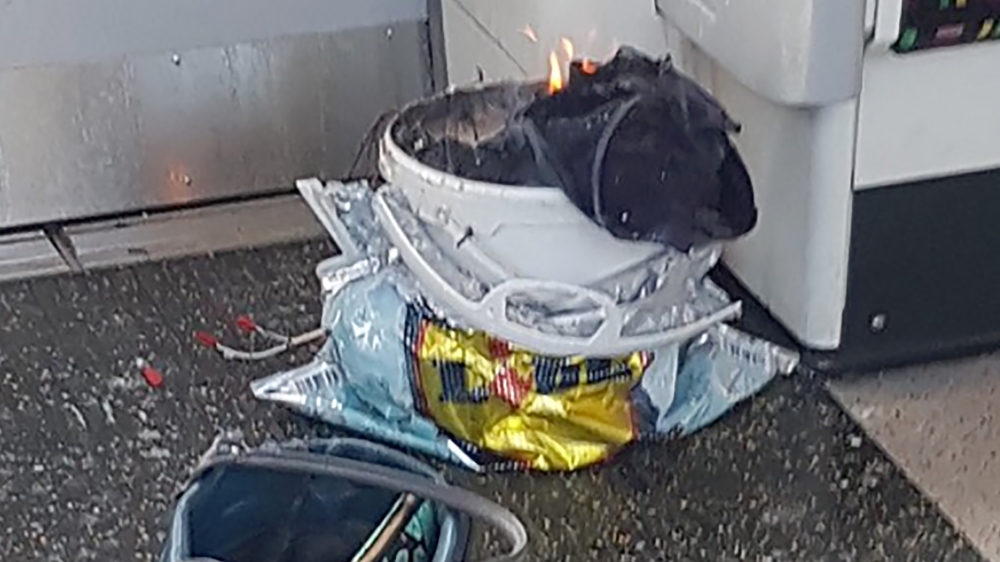 A handout picture obtained from the Twitter user @sylvainpennec shows a white container burning inside a London underground tube [AFP]
