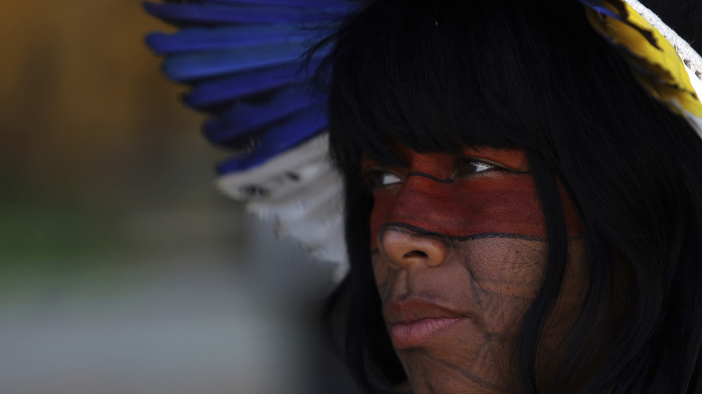 Indigenous women protest President Michel Temer's plan to restrict land titles in Brasilia last month [Eraldo Peres/AP]