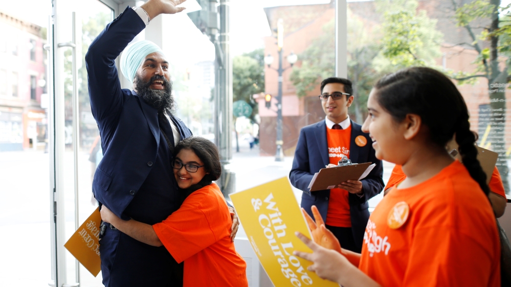 Singh Is hugged at a meet and greet event in Hamilton, Ontario, in July [Mark Blinch/Reuters]
