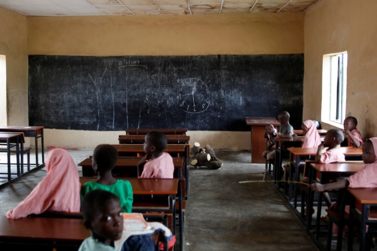 Pupils sit in a classroom at the Hausari primary school in Michika village.