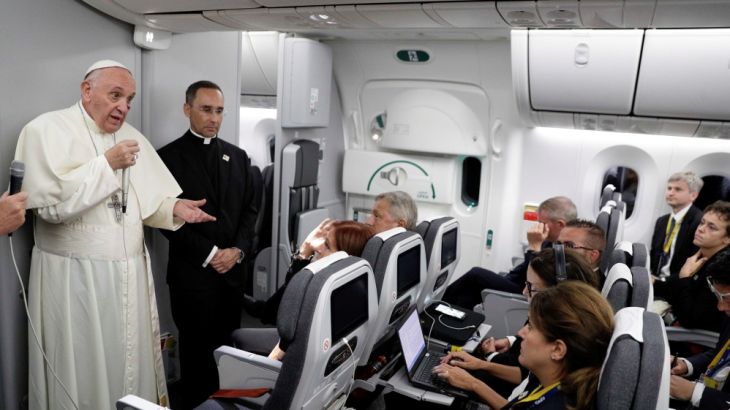 Pope Francis talks to journalists during a press conference aboard a plane to Rome at the end of his visit to Colombia