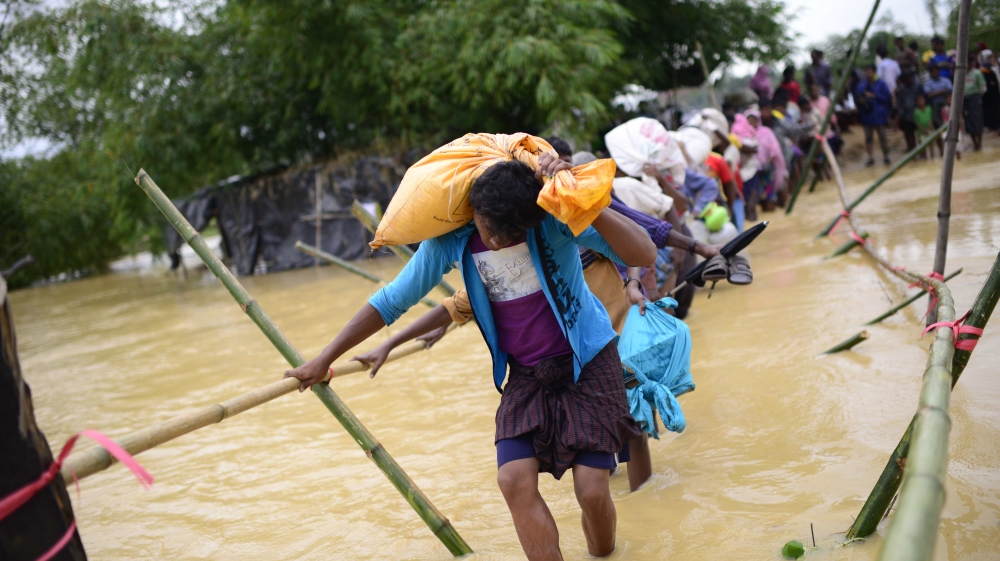 The rain caused flooding in many makeshift camps, forcing people to move to new areas [Mahmud Hossain Opu/Al Jazeera]