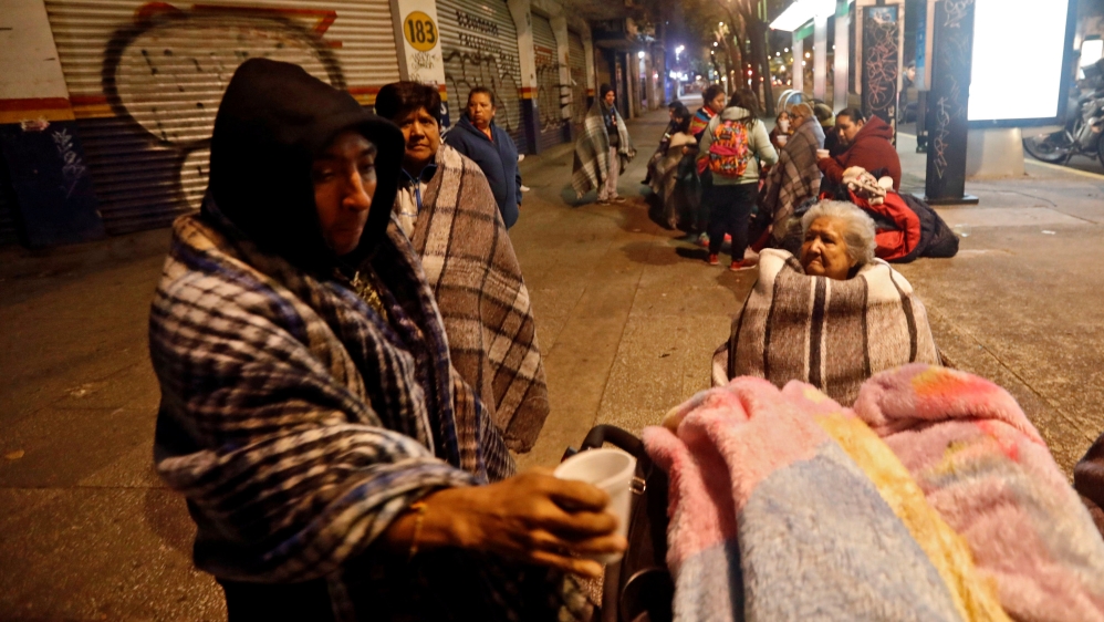 People gather on a street after the earthquake hit Mexico City [Reuters]