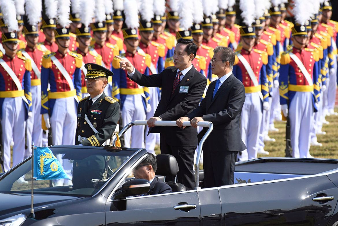 South Korean President Moon Jae-in, right, and Defense Minister Song Young-moo, center, review the troops during a commemoration ceremony marking South Korea''s Armed Forces Day, which will fall on Oct