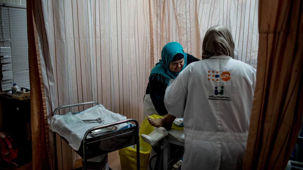Midwives deliver a baby at the Women's and Girl's Comprehensive Center [Hannah Long-Higgins/Al Jazeera]