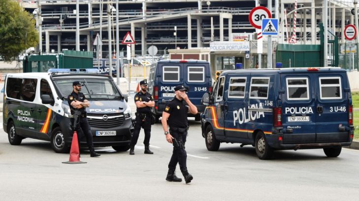 Spanish national police vehicles enter the port where hundreds of Spanish national police and civil guard reinforcements are housed in two ferries a day before the banned