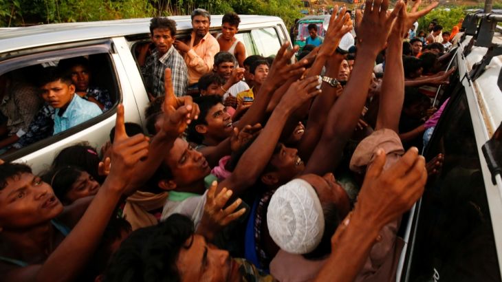 Rohingya refugees stretch their hands for food near Balukhali in Cox’s Bazar