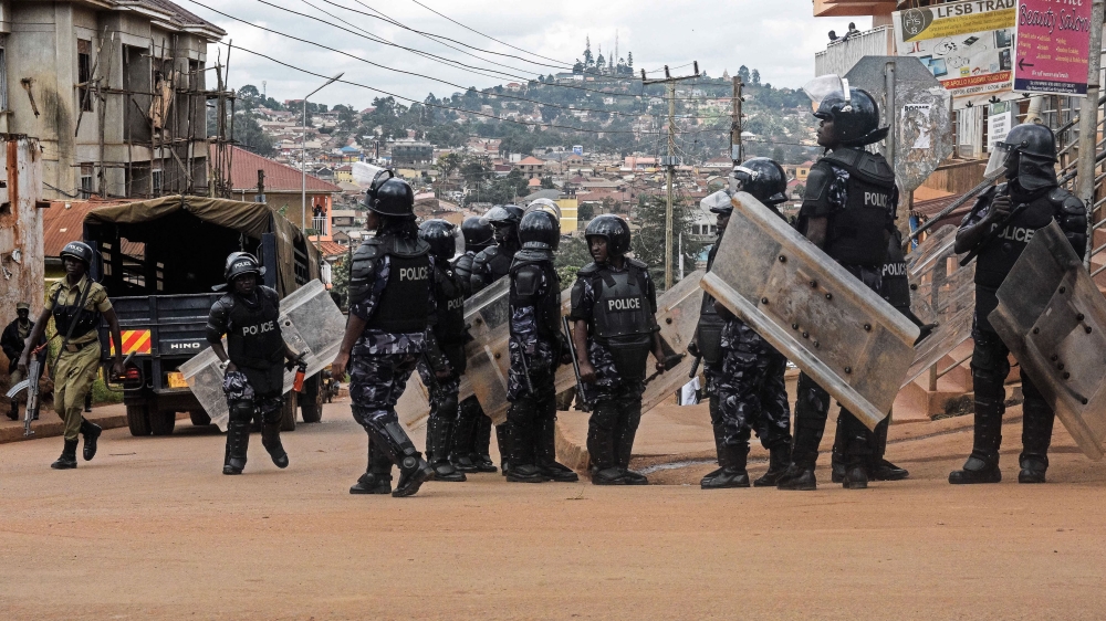 Security forces arrested 19 people, including opposition figure Kizza Besigye, before Wednesday's parliamentary session [Isaac Kasamani/AFP]