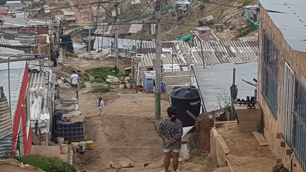The neighbourhood of Soacha, south of Colombia's capital Bogota, is home to hundreds of thousands of internally displaced people. Most of the houses are poorly constructed and live in communities without running water, electricity or sanitation. It's common for two or three families to share the same dwelling [Dimitri O'Donnell/Al Jazeera]