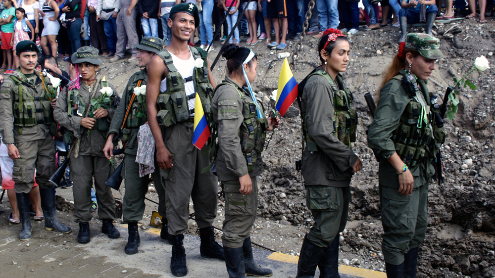FARC rebels line up to board a ferry taking them to the transition camp La Carmelita near Puerto Asis in Colombia's southwestern state of Putumayo [Chantal Flores/Al Jazeera]