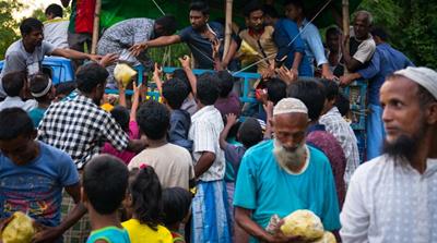 Rohingya refugees compete for food parcels near Kutupalong camp [Katie Arnold/Al Jazeera] 