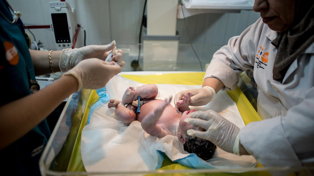 Staff tend to a newborn minutes after the baby is born [Hannah Long-Higgins/Al Jazeera]