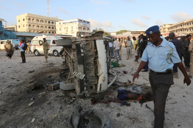 Somali security officers secure the scene of a car explosion in Hamarweyne district of Mogadishu
