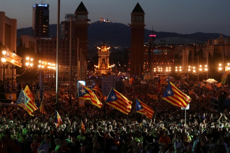 People wave Esteladas (Catalan separatist flags)
