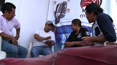 Former Honda employees who claim they were fired after trying to unionise meet in Guadalajara to discuss future strategies for creating a union. The former employees have a weekly radio show on a community radio station to raise awareness about unions [Screengrab/Al Jazeera]