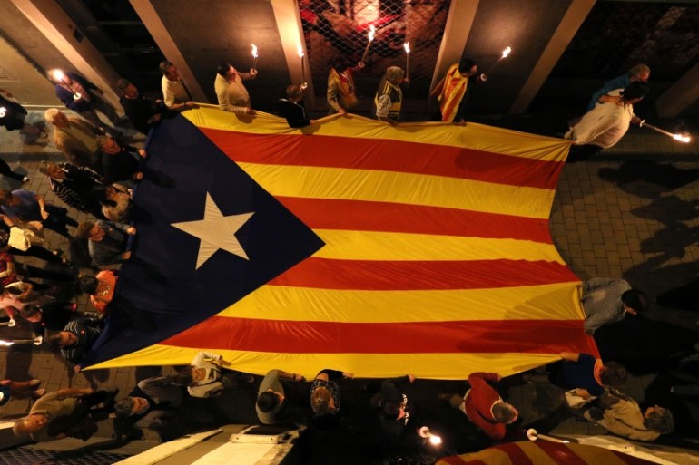 People carry a giant Estelada (Catalan separatist flag) during a torch march in Vilafranca del Penedes