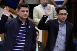 Paolo Duterte, Davao Vice Mayor and son of President Rodrigo Duterte, and his brother in law Manases Carpio take oath during a Senate hearing on drug smuggling in Pasay, Metro Manila
