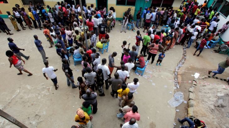 People wait to vote during the presidential election at a polling station in Monrovia