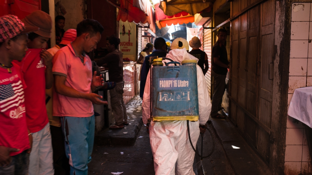 A council worker sprays disinfectant during the clean-up of the market of Anosibe in the Anosibe district, an Antananarivo district [Rijasolo/AFP]