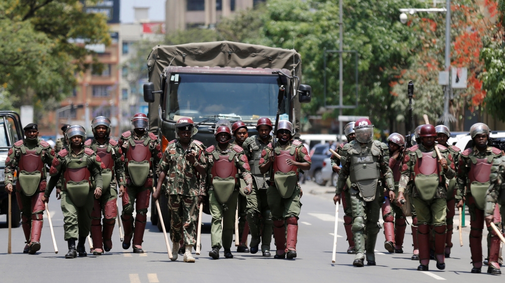 Riot policemen walk along a street in an attempt to disperse supporters of Kenyan opposition National Super Alliance (NASA) coalition, during a protest along a street in Nairobi, Kenya, October 16 [Thomas Mukoya/Reuters]