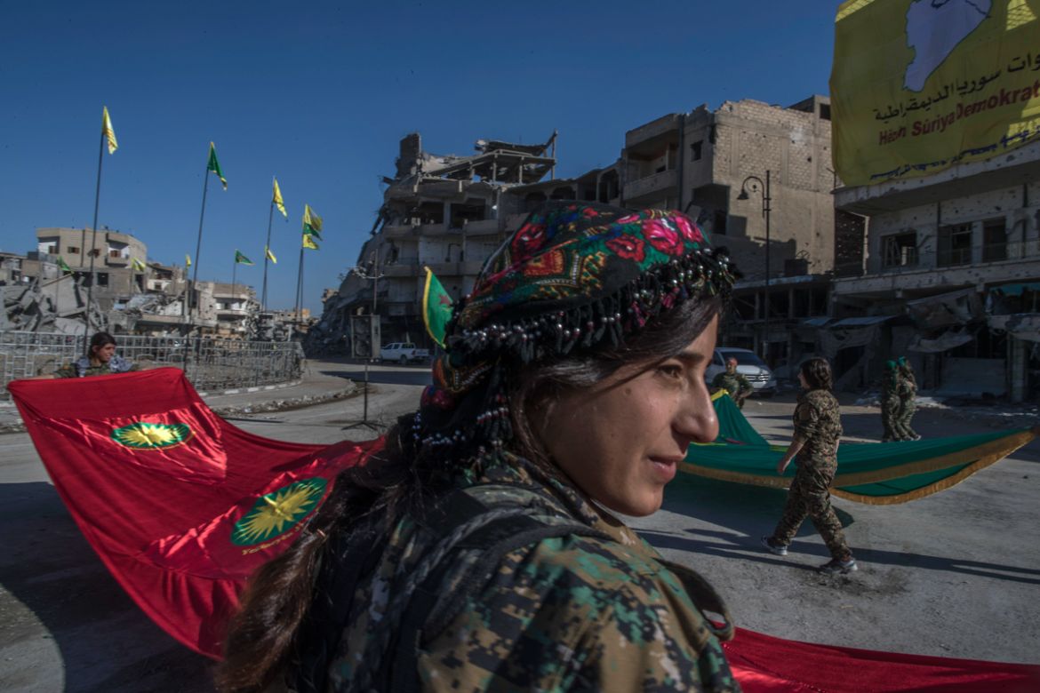 Fighters from the Women''s Protection Units, or YPJ, hold a celebration in Paradise Square in Raqqa, Syria. The Kurdish female militia that took part in freeing the northern Syrian city of Raqqa from t