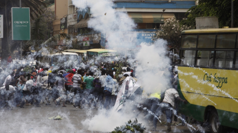 Riot police fire tear gas against opposition supporters during a demonstration against the Independent Electoral and Boundaries Commission in Nairobi, Kenya [Khalil Senosi/AP Photo]
