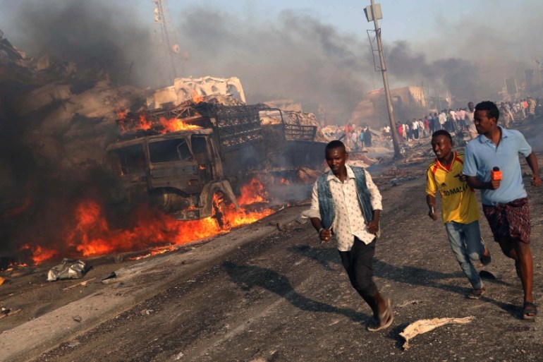 Civilians evacuate from the scene of explosion in Mogadishu