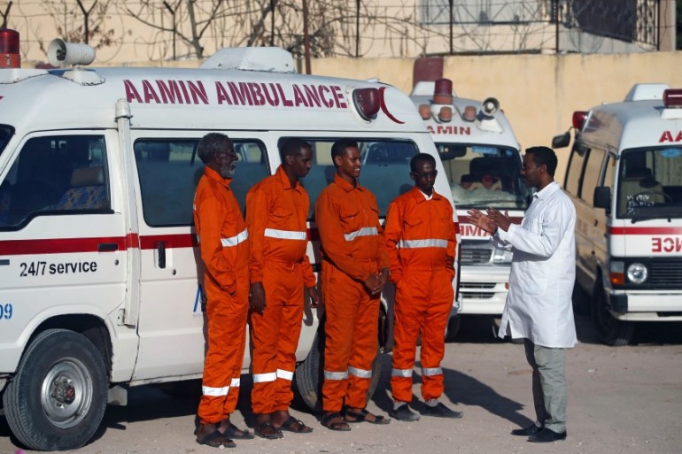 Somali dentist Dr. Abdulkadir Abdurrahman, the founder of Aamin Ambulance, speaks to his crew members before going for an emergency operation in Mogadishu