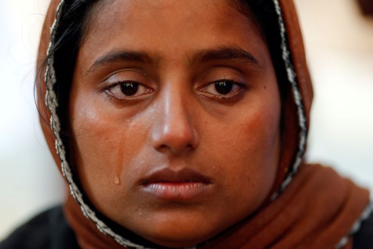 Nur Fatema, a survivor, cries over the body of her nine month old son who died after a boat with Rohingya refugees capsized as they were fleeing Myanmar, before bodies of victims were taken for the ma