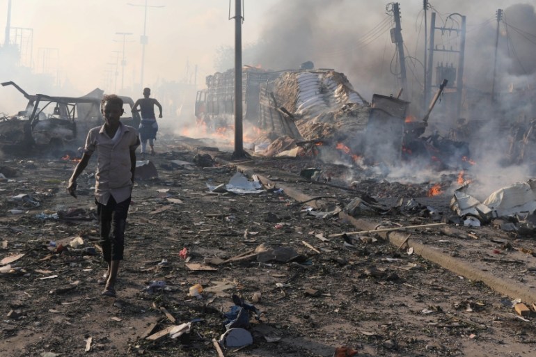 Civilians evacuate from the scene an explosion in KM4 street in the Hodan district in Mogadishu