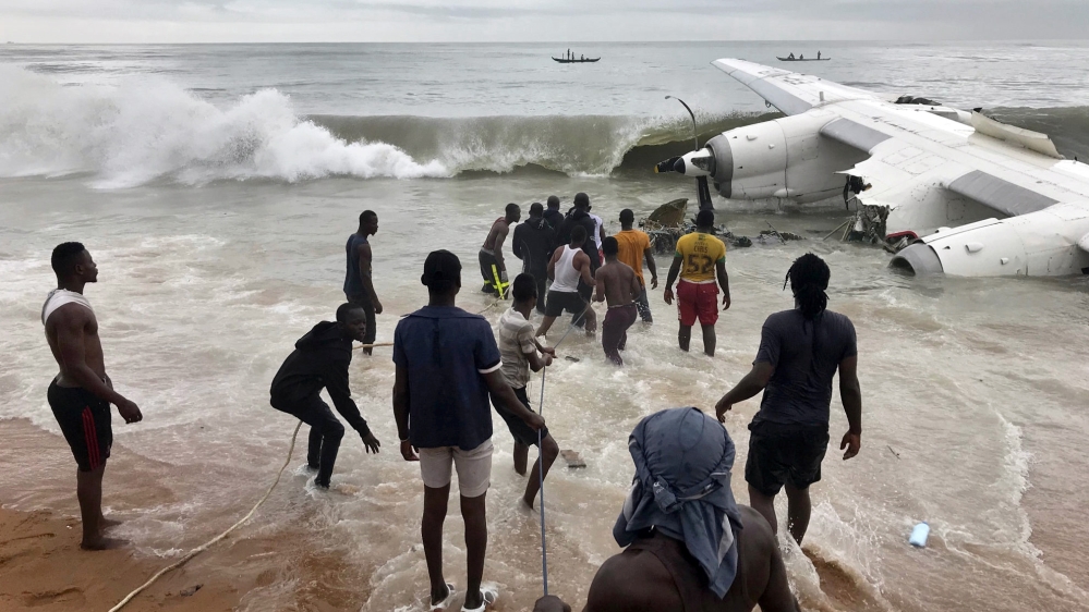 Rescuers pull the wreckage of the cargo plane out of the sea [Ange Aboa/Reuters]
