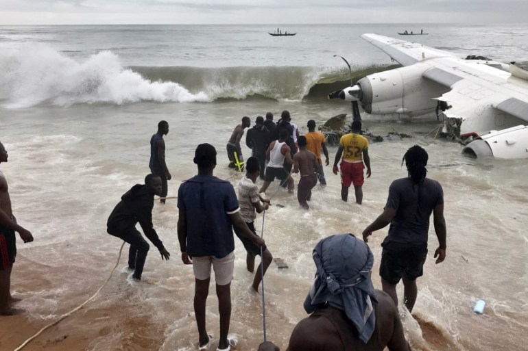 Rescuers pull the wreckage of a cargo plane out of sea after it crashed near the international airport in Abidjan
