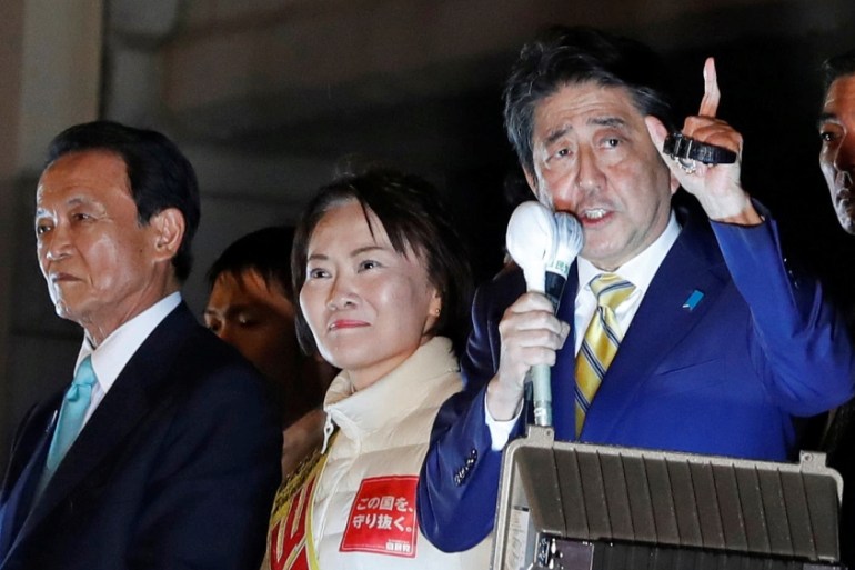 Japan''s Prime Minister Shinzo Abe, leader of the Liberal Democratic Party, and Japan''s Deputy Prime Minister Taro Aso attend an election campaign rally in Tokyo