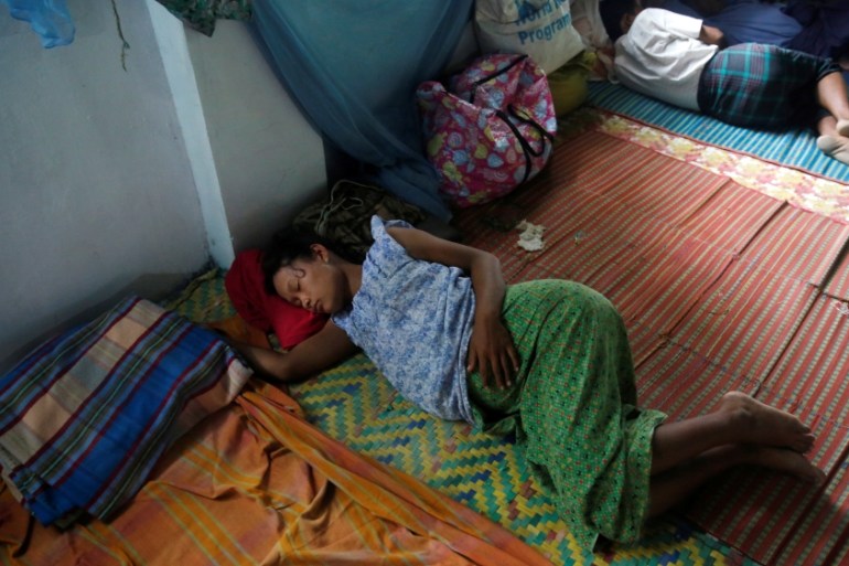 Ethnic Rakhine pregnant woman who fled from violence in her village sleeps at a temporary internally displaced persons (IDP) camp in Sittwe