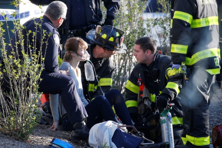 A woman is aided by first responders after sustaining injury on a bike path in lower Manhattan in New York